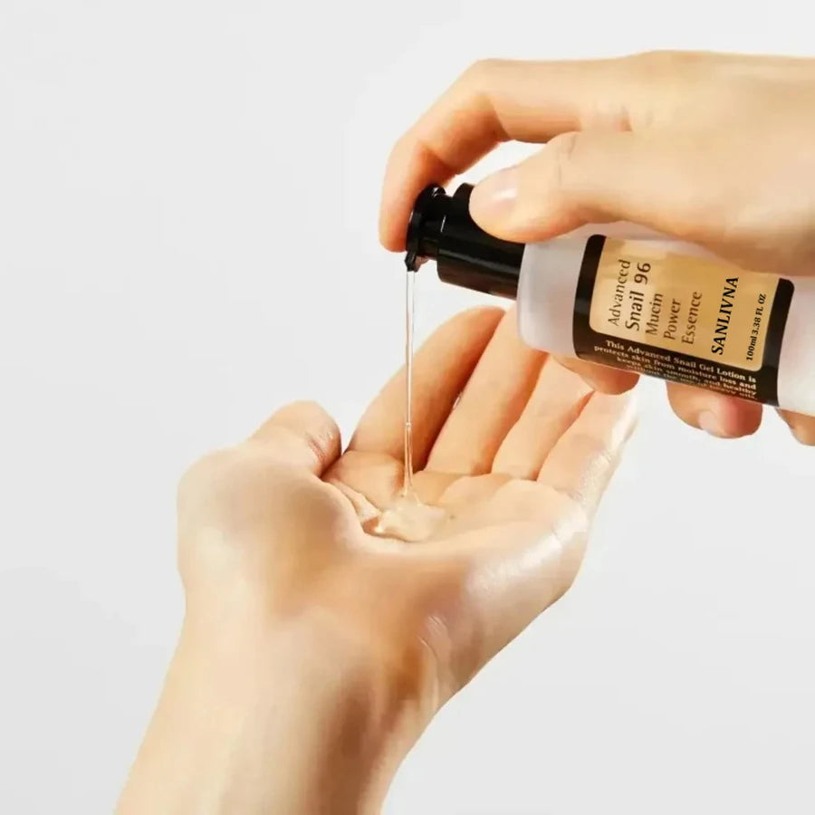 Woman applying SANLIVNA snail mucin essence to face – anti-aging and brightening skincare routine